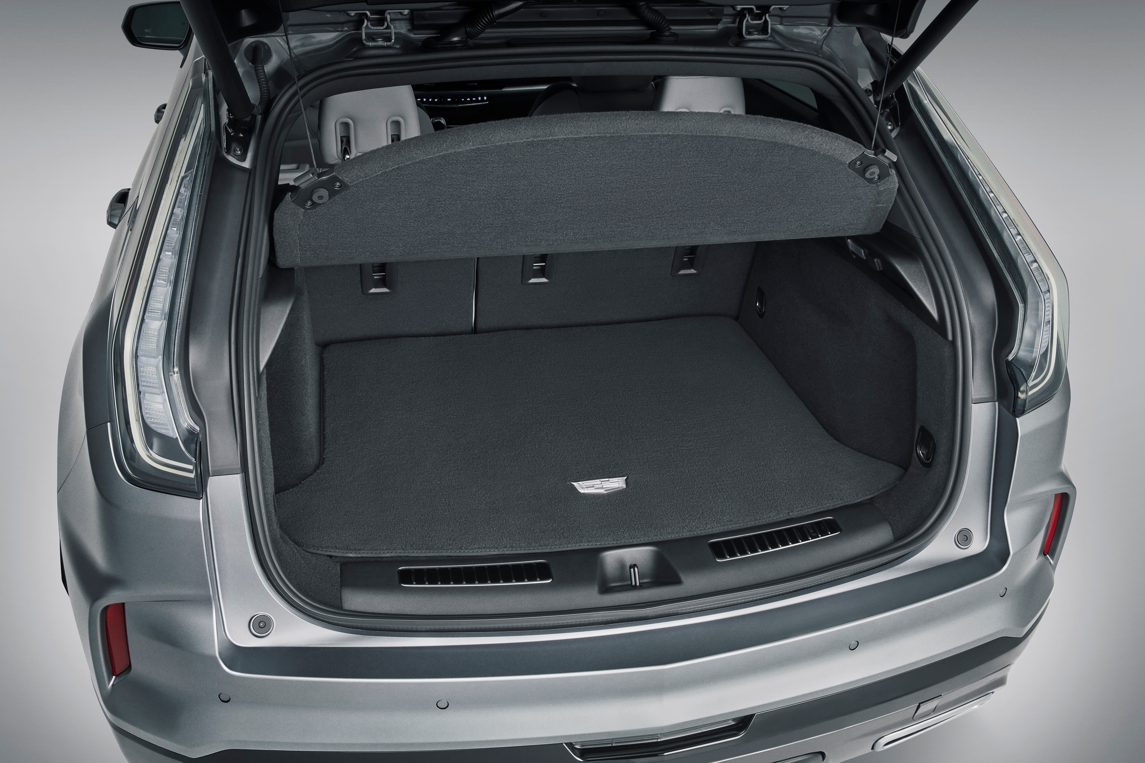 Premium Carpeted Cargo Area Mat in Jet Black with Cadillac Logo