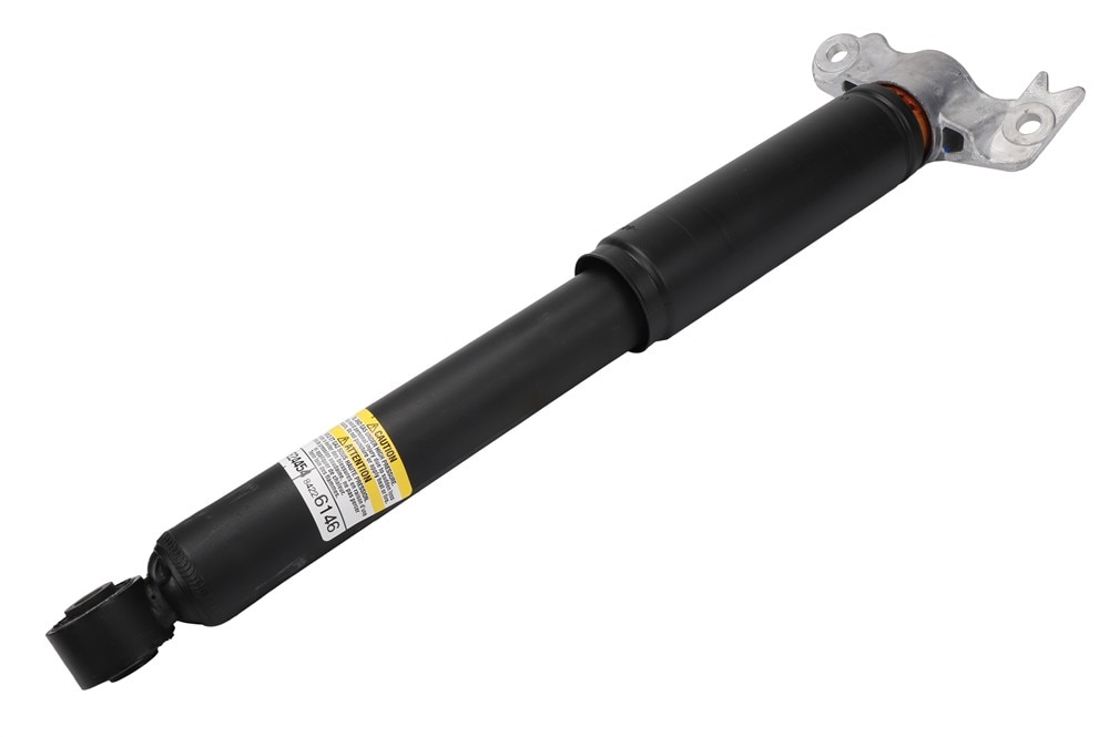 GM Genuine Parts Rear Driver Side Shock Absorber with Bumper, Upper Mount, and Nut